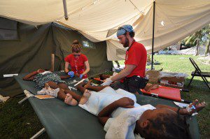 CMAT Nurses Aric Rankin and Maida Mrakovic treat children for dehydration in Haiti. 