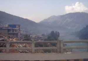 A photo of the destruction in the city of Muzaffarabad from the main bridge over the river Neelum.