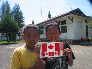 Happy Indonesian boys display Canadian flag stickers they received from our team. (January, 2005).