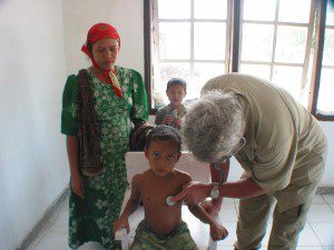 CMAT physician Dr. Dave Ratcliffe from Comox, B.C. assesses a child in Meuloboh, Indonesia (January, 2005)