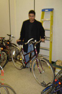 MacCycle director, Mr. Pradeep Singh stands with McMaster University President Mr. Peter George's donated bicycle.