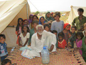 A family photo of Internally Displaced People (IDP) in a camp near where CMAT and IMAT will be working in southern Pakistan. Notice the colour of the drinking water in the bottle - it's the colour of tea with milk. Donations are needed to buy a large water purification unit.