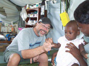 CMAT Nurse John Stone treats a young girl in Leogane. 