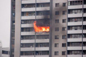 Flames broke out in a unit on the 24th floor, but continued to burn five hours later and spread to adjacent apartments.