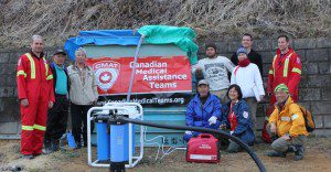 CMAT paramedic Martin Metz and OT Seiko Watanabe install a Nomad water purification system in the town of Aikawa Kitakamicho.