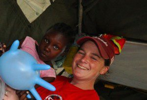 CMAT Volunteer Kelly Kaley, with a young patient in Haiti. 