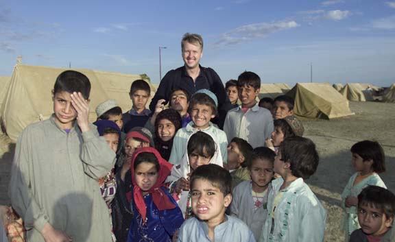 CMAT Volunteer Webmaster Mikael Kjellström with children in Afghanistan. 
