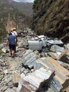 A car is crushed in a rockslide after a 7.9 magnitude earthquake struck Nepal April 25, 2015
