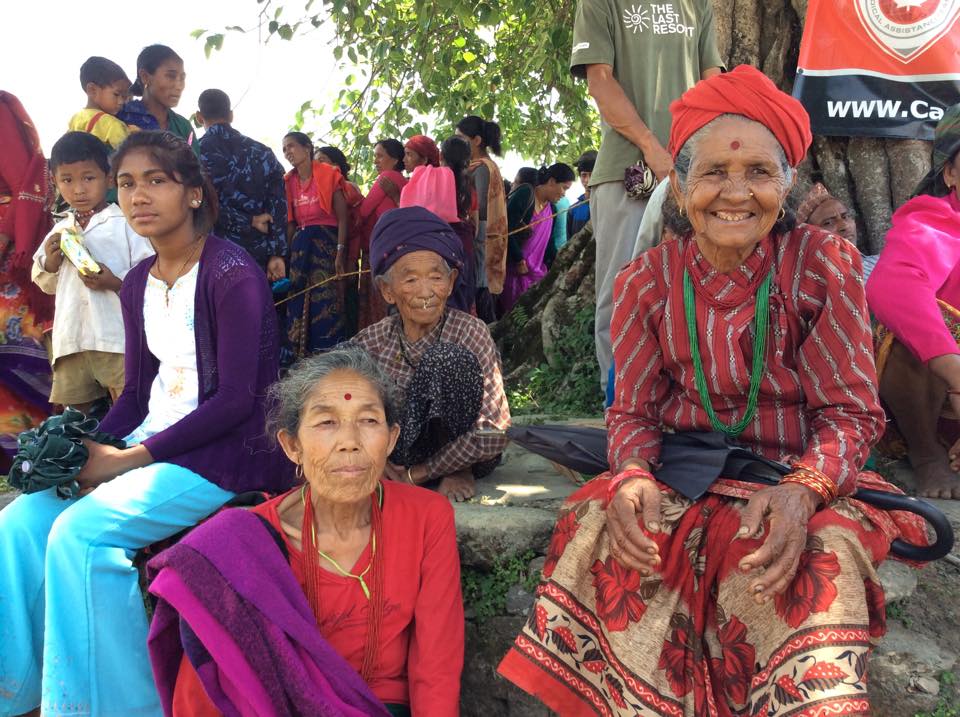 Women gather under a tree for shade, while waiting for their turn at the CMAT clinic in Takukot, Nepal 